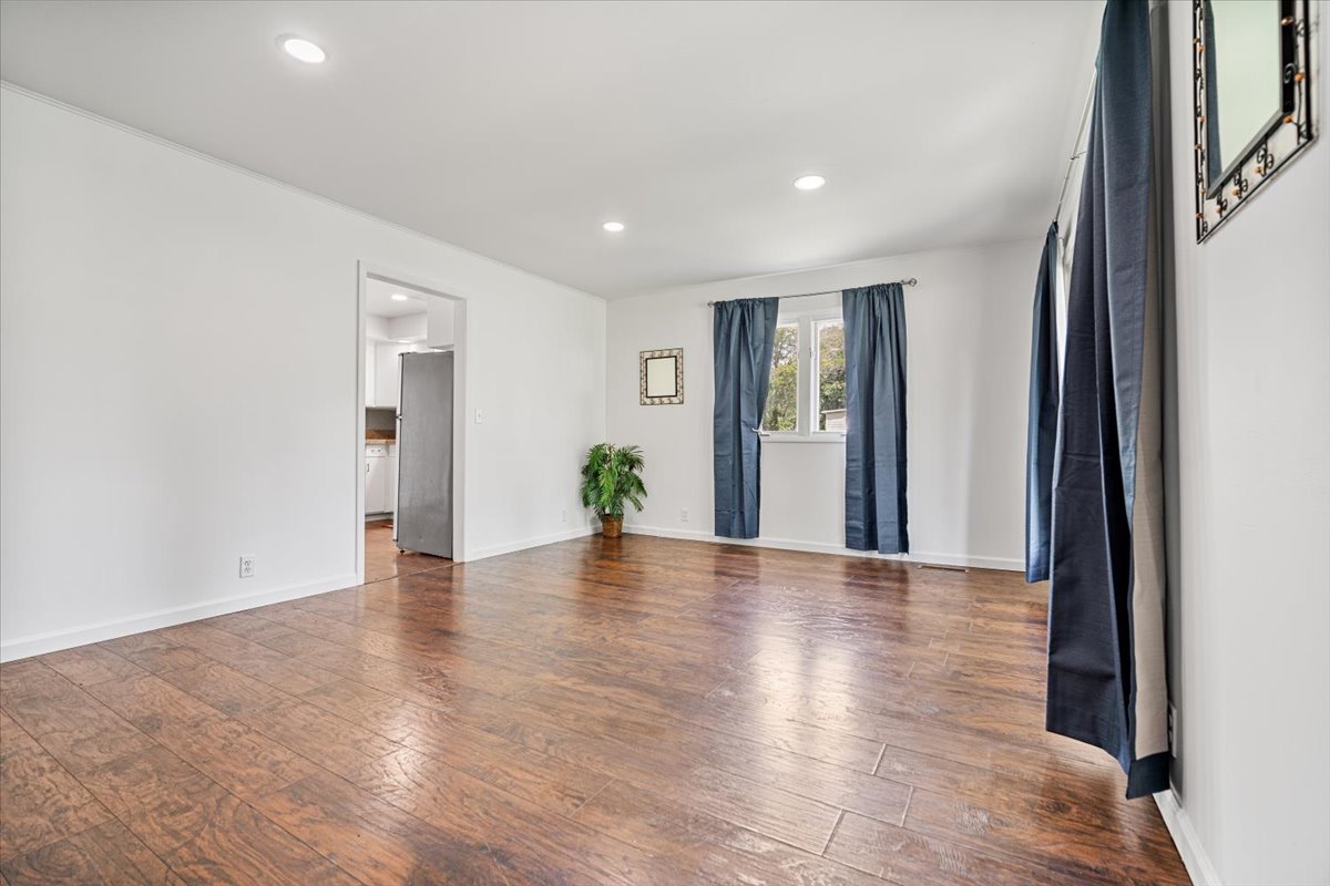 396 North Sherman Street El Paso, IL 61738 - Photo 3 of 29 a view of an empty room with wooden floor and a window