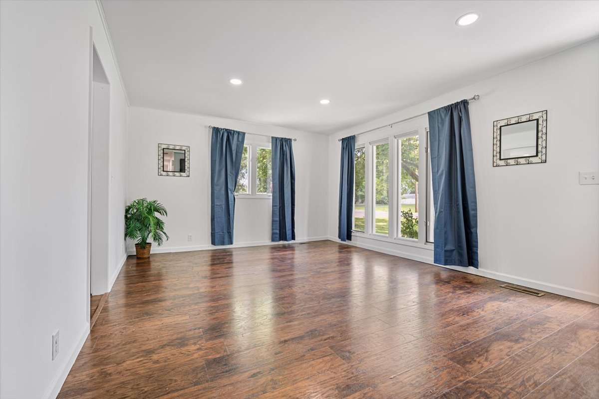 396 North Sherman Street El Paso, IL 61738 - Photo 6 of 29 a view of an empty room with wooden floor and a window