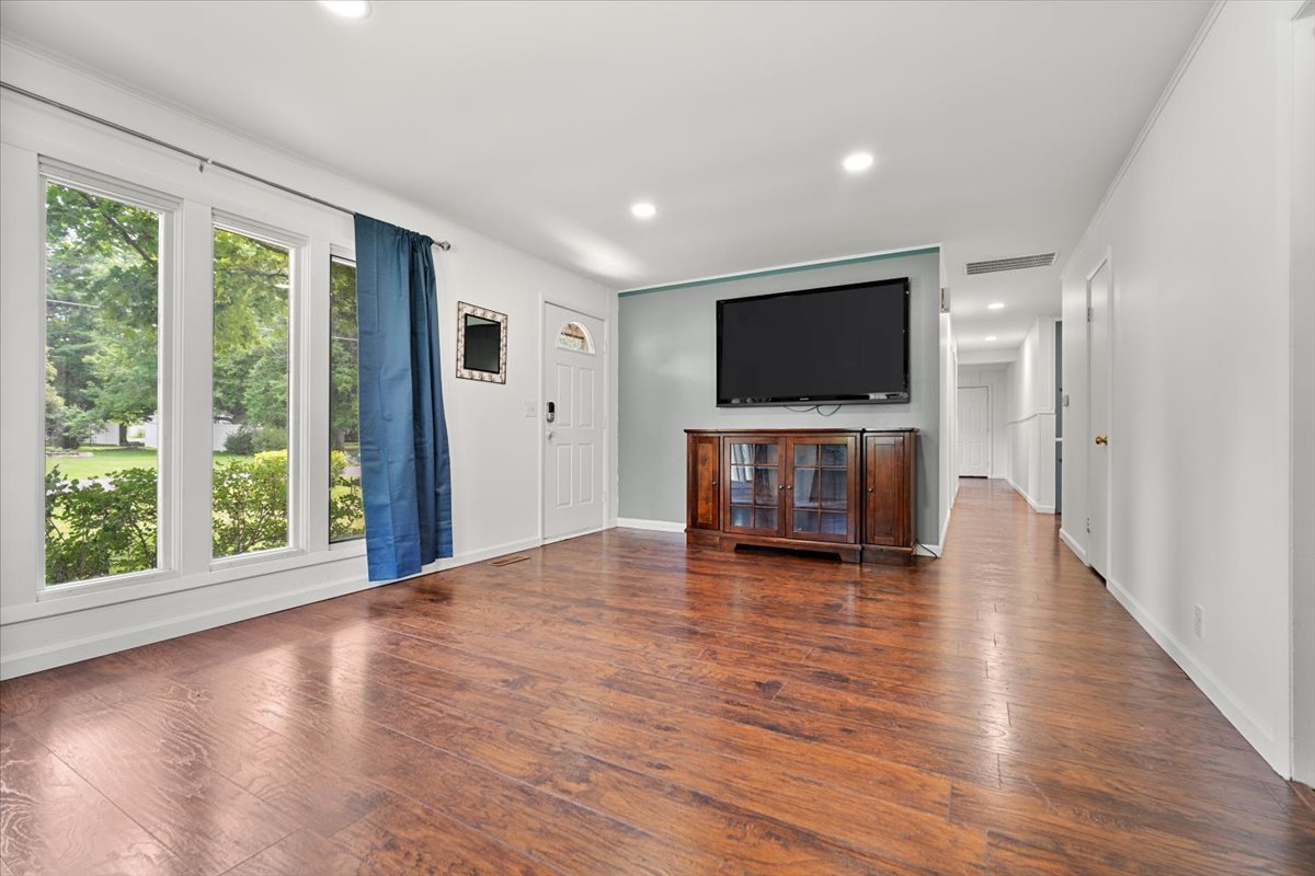 396 North Sherman Street El Paso, IL 61738 - Photo 7 of 29 a view of a livingroom with wooden floor and a flat screen tv
