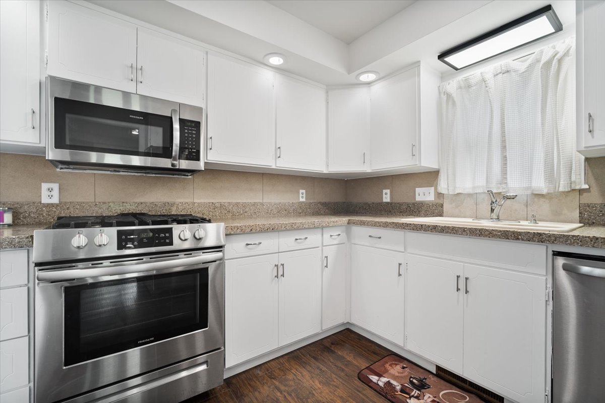 396 North Sherman Street El Paso, IL 61738 - Photo 10 of 29 a kitchen with stainless steel appliances granite countertop a stove microwave and oven