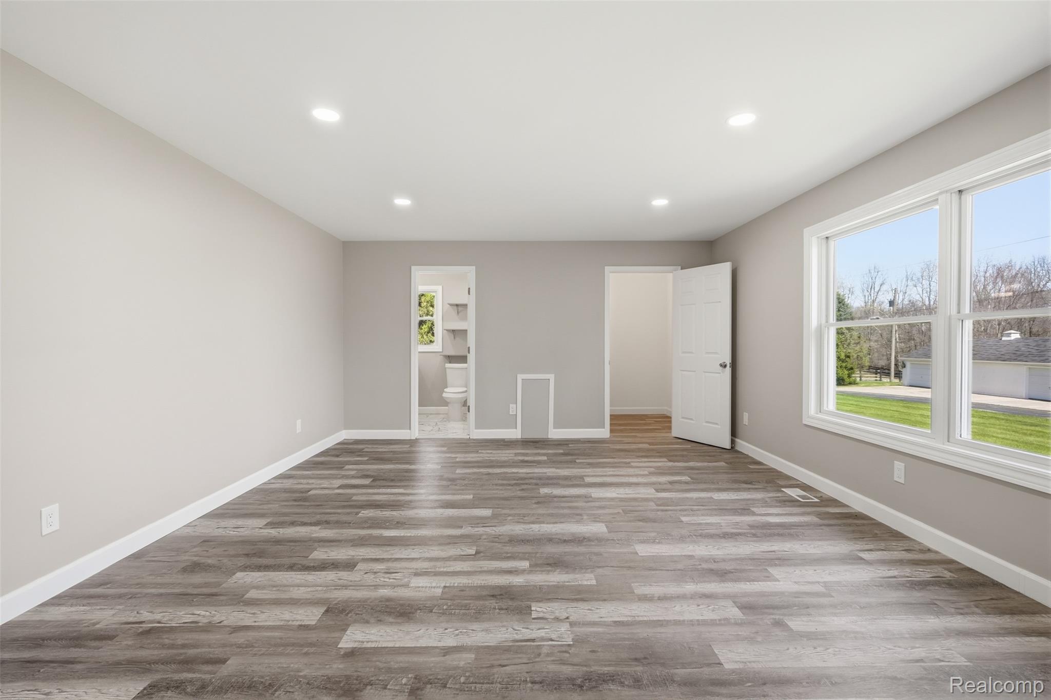 8636 Tindall Road Davisburg, MI 48350 - Photo 26 of 61 Unfurnished bedroom featuring light wood finished floors, recessed lighting, and ensuite bathroom