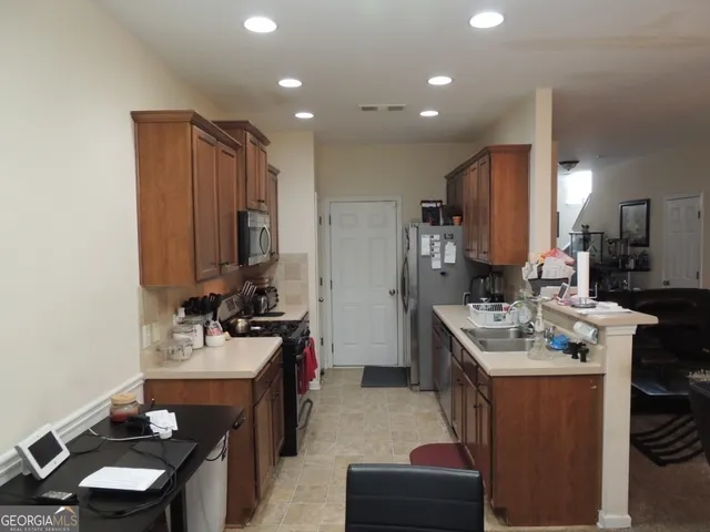 a kitchen with kitchen island a sink stove and cabinets