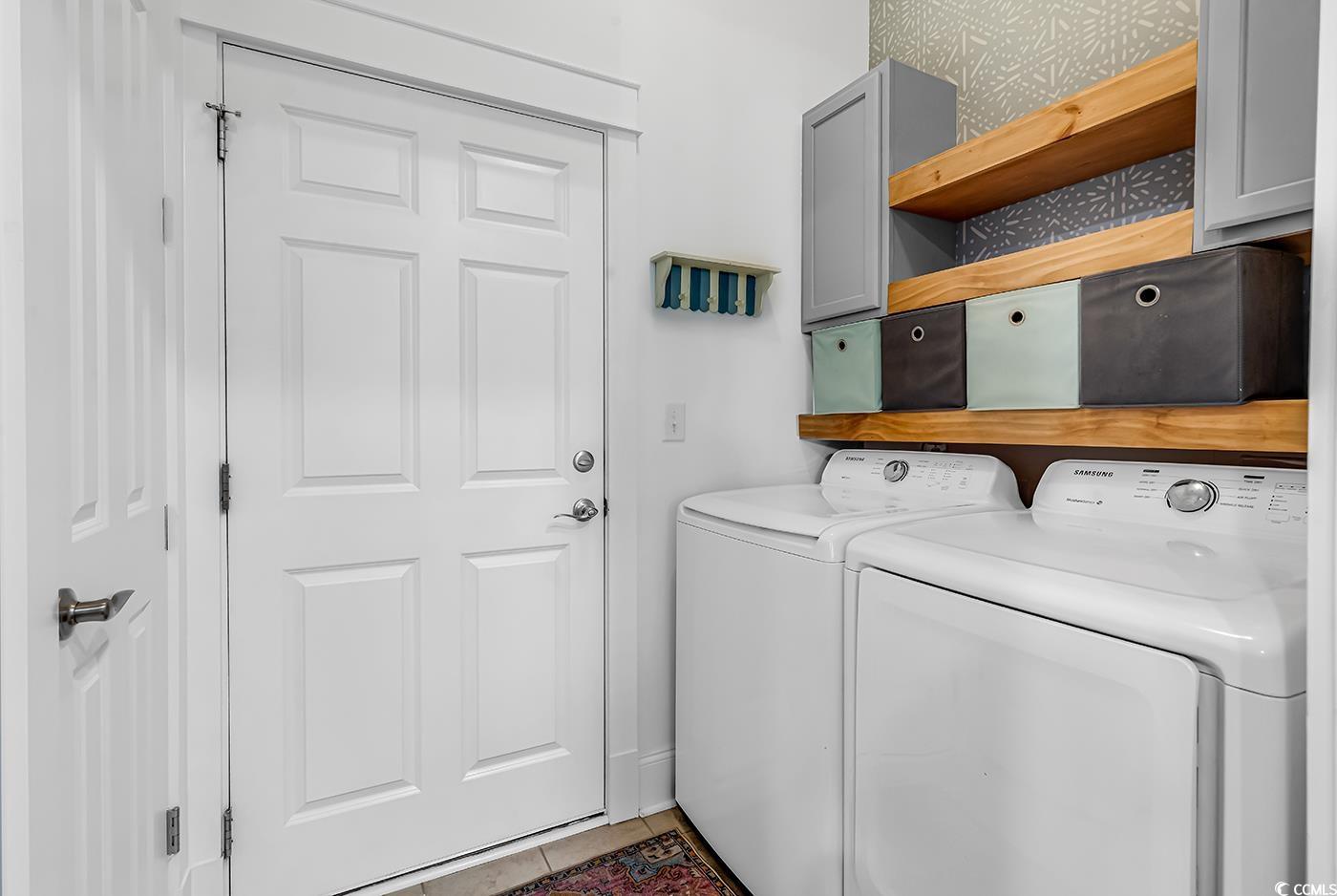 1411 Peterson Street Myrtle Beach, SC 29577 - Photo 11 of 40 Laundry area featuring tile patterned floors, separate washer and dryer, and cabinet space