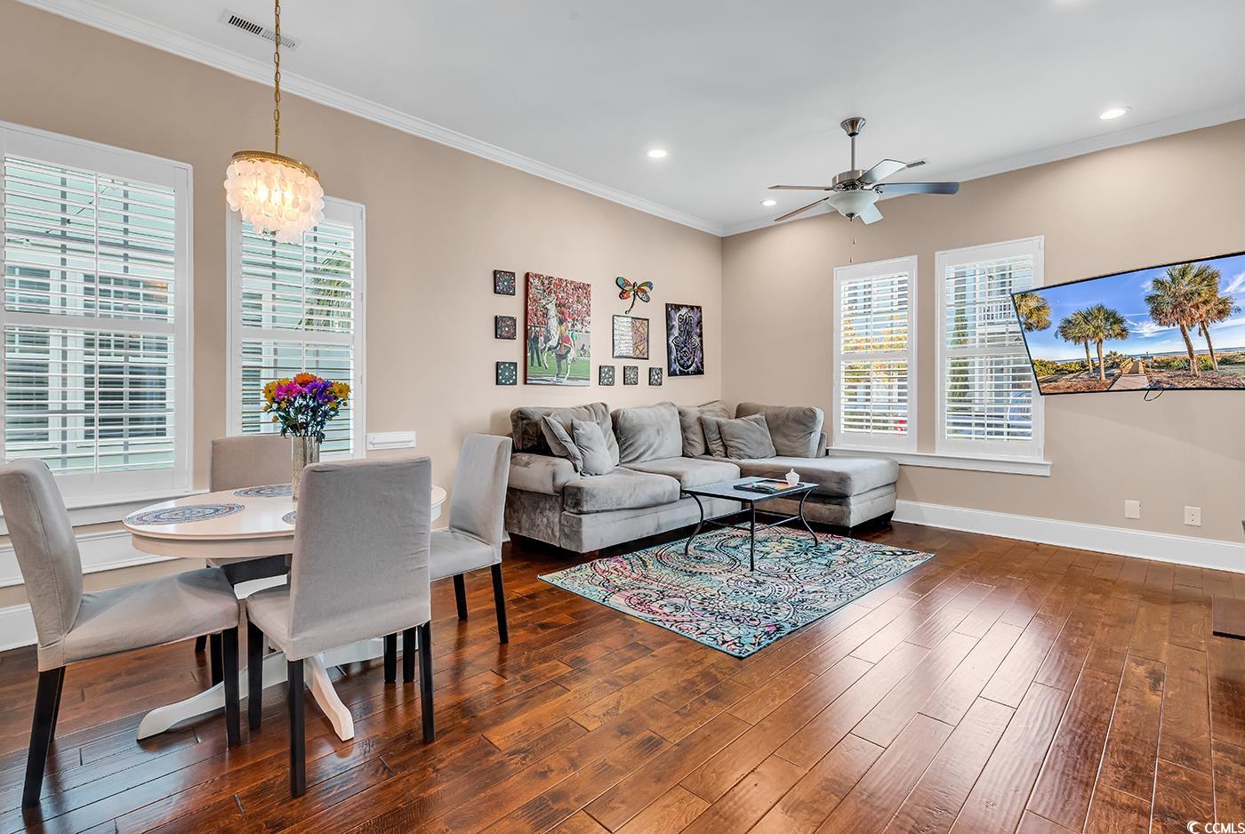 1411 Peterson Street Myrtle Beach, SC 29577 - Photo 12 of 40 Living room featuring ornamental molding, dark wood-type flooring, recessed lighting, a ceiling fan, and a chandelier