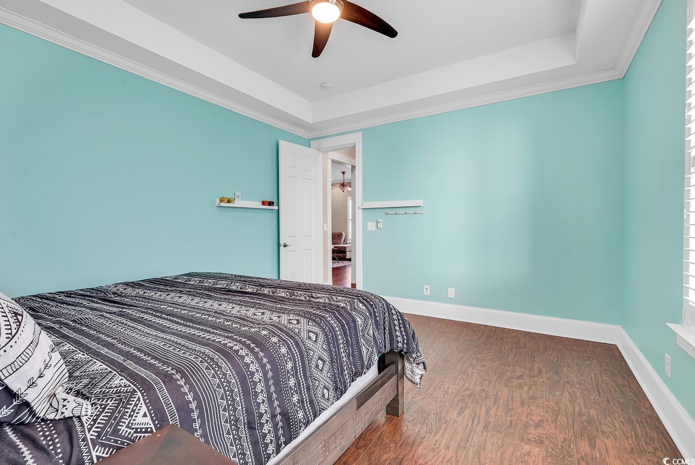 1411 Peterson Street Myrtle Beach, SC 29577 - Photo 15 of 40 Bedroom featuring a raised ceiling, dark wood finished floors, ornamental molding, and a ceiling fan