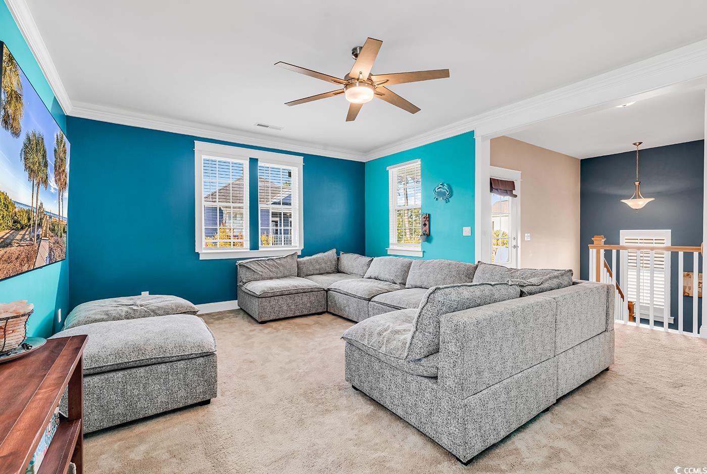 1411 Peterson Street Myrtle Beach, SC 29577 - Photo 21 of 40 Living area with ornamental molding, carpet flooring, and a ceiling fan