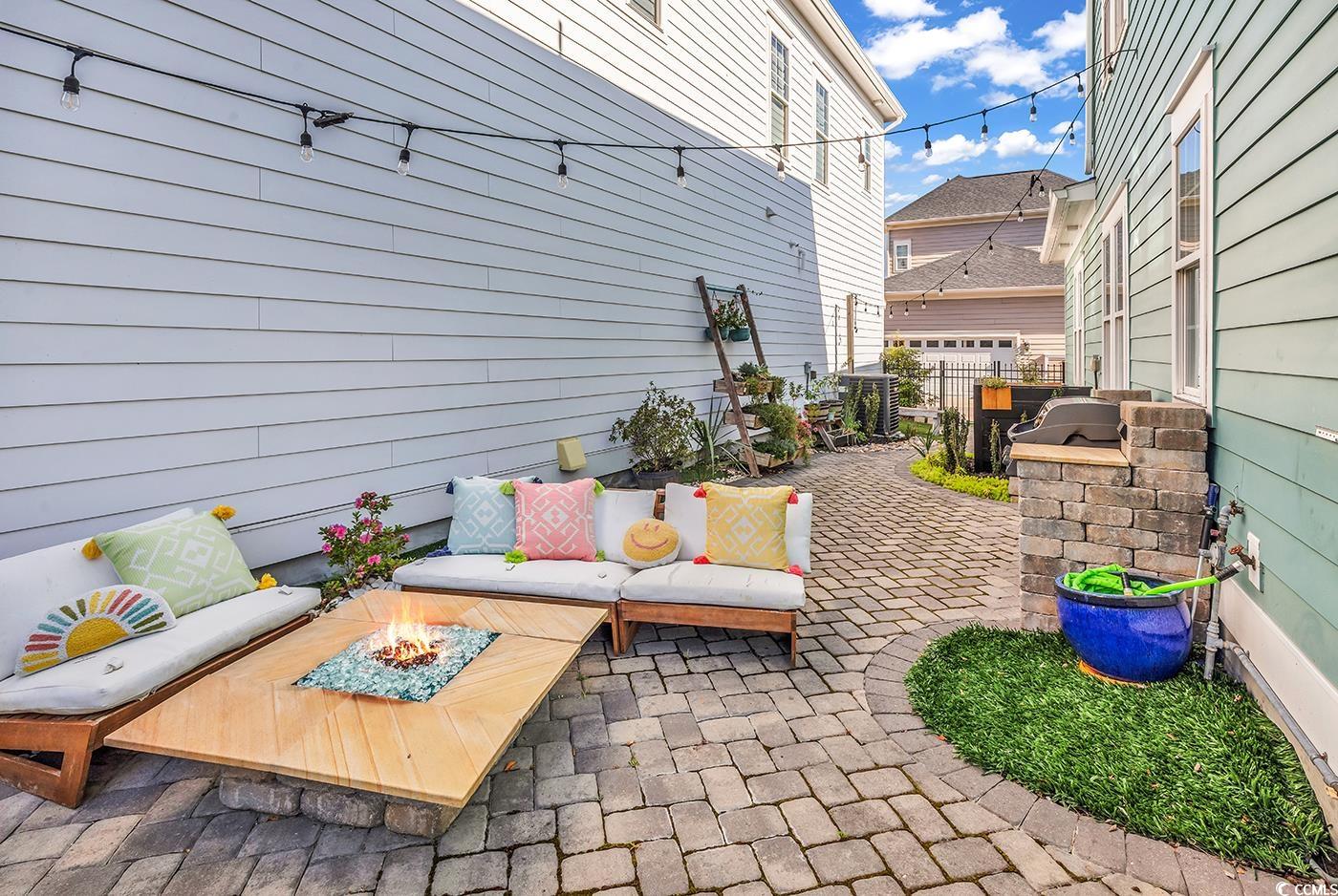1411 Peterson Street Myrtle Beach, SC 29577 - Photo 30 of 40 View of patio featuring an outdoor living space with a fire pit