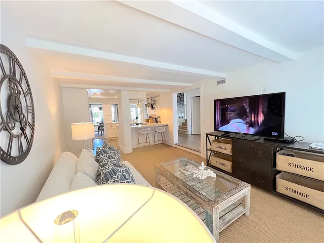 a large white bed sitting in a bedroom and lamp
