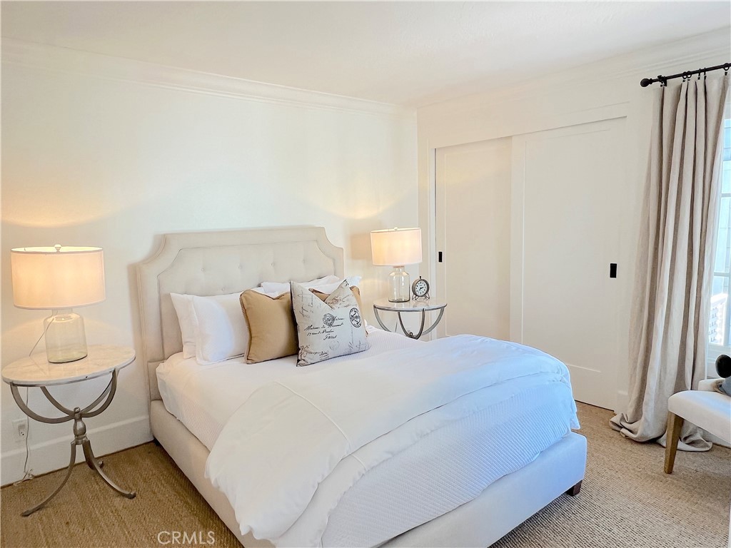 33908 Cape Cove Dana Point, CA 92629 - Photo 33 of 71 a bedroom with a bed a chair and painting on the wall