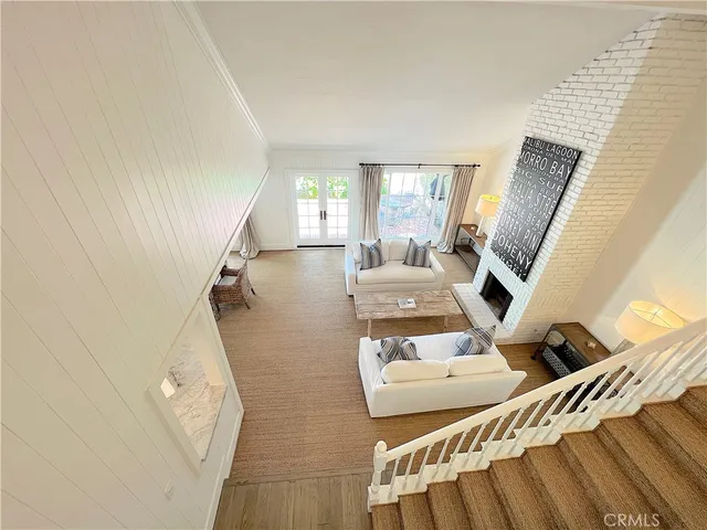 a bedroom with two beds and a large window