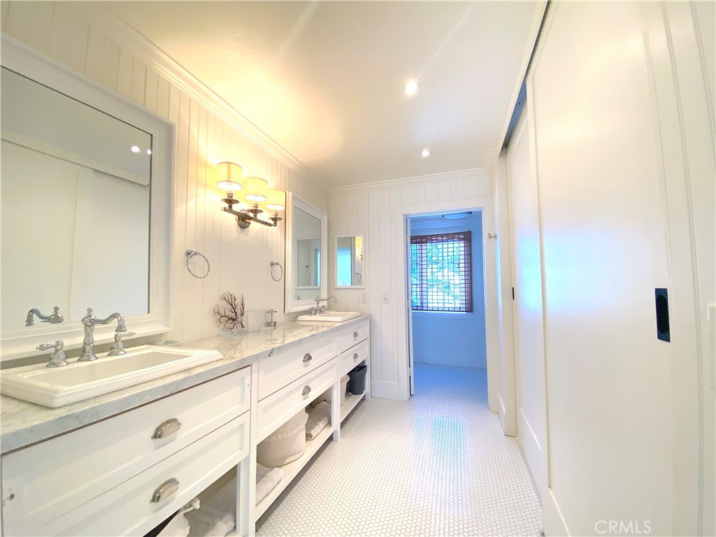 33908 Cape Cove Dana Point, CA 92629 - Photo 44 of 71 a bathroom with a double vanity sink and mirror