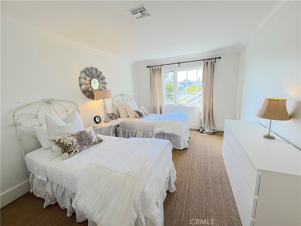 33908 Cape Cove Dana Point, CA 92629 - Photo 51 of 71 a spacious bedroom with two beds and a table