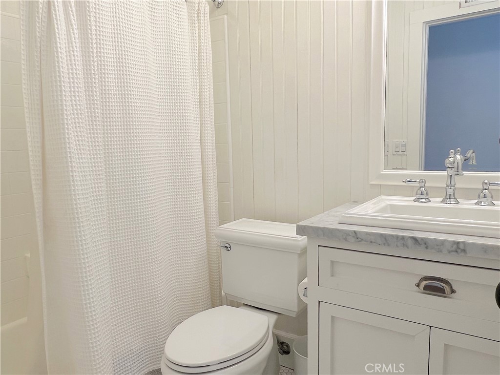 33908 Cape Cove Dana Point, CA 92629 - Photo 53 of 71 a bathroom with a sink a toilet and a mirror