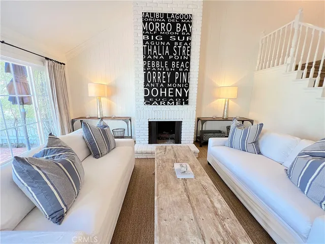 a view of a living room with furniture and wooden floor
