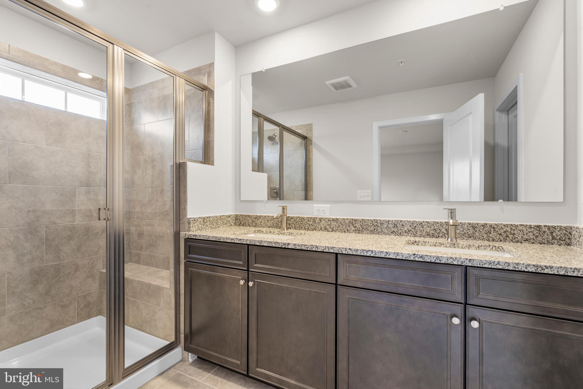 1826 Parham Way Windsor Mill, MD 21244 - Photo 24 of 37 a bathroom with a granite countertop sink mirror and double