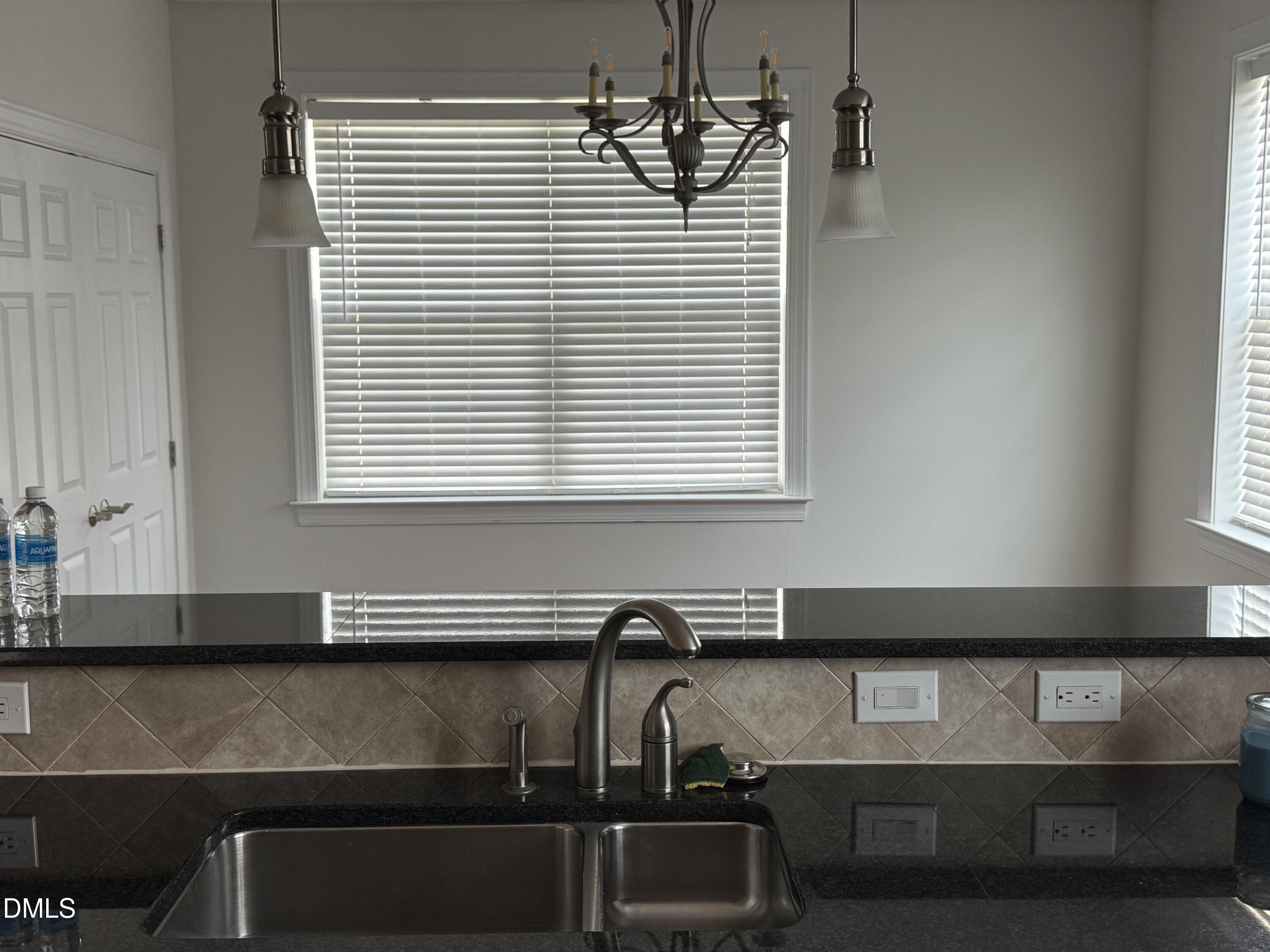 10511 Rosegate Court Raleigh, NC 27617 - Photo 7 of 26 a kitchen with a sink and a microwave