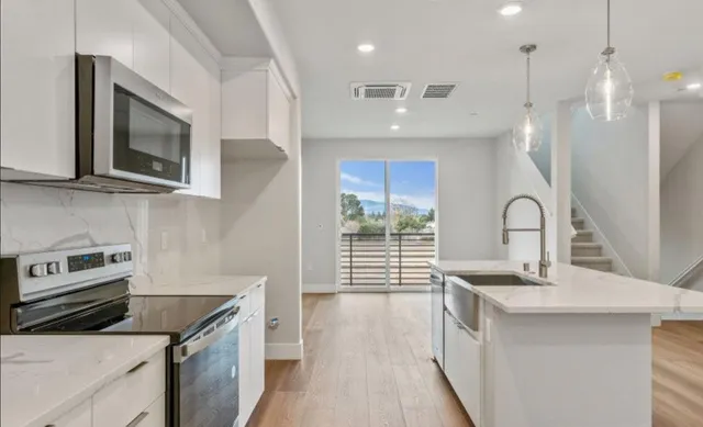 a kitchen that has a sink and a stove in it