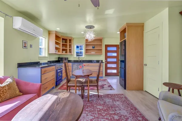a living room with furniture and a book shelf