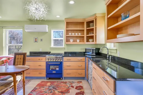 a kitchen with a dining table chairs and chandelier