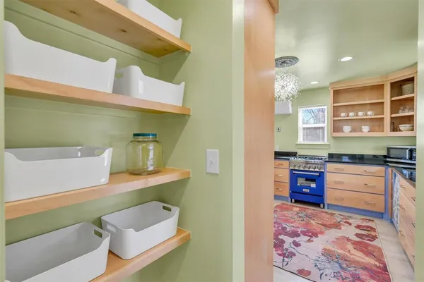 a hallway with a bed and a couch