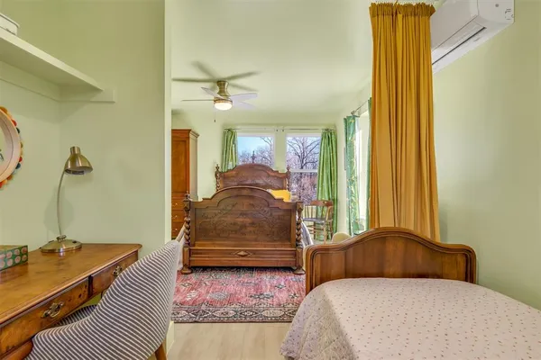 a bedroom with a bed and a dresser