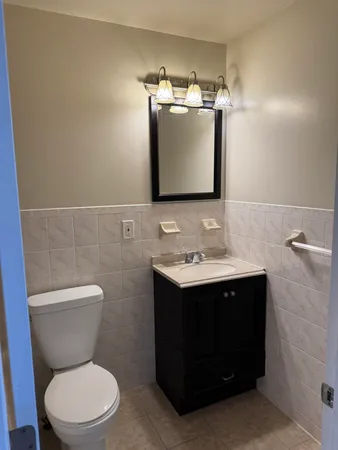 a bathroom with a sink a toilet and a mirror