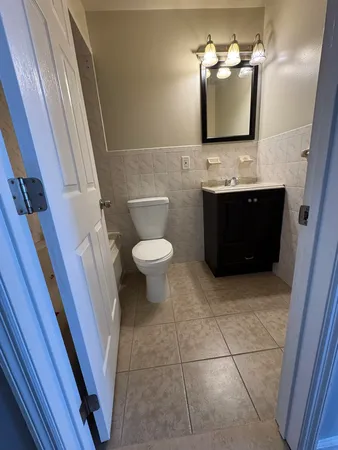 a bathroom with a toilet sink and mirror