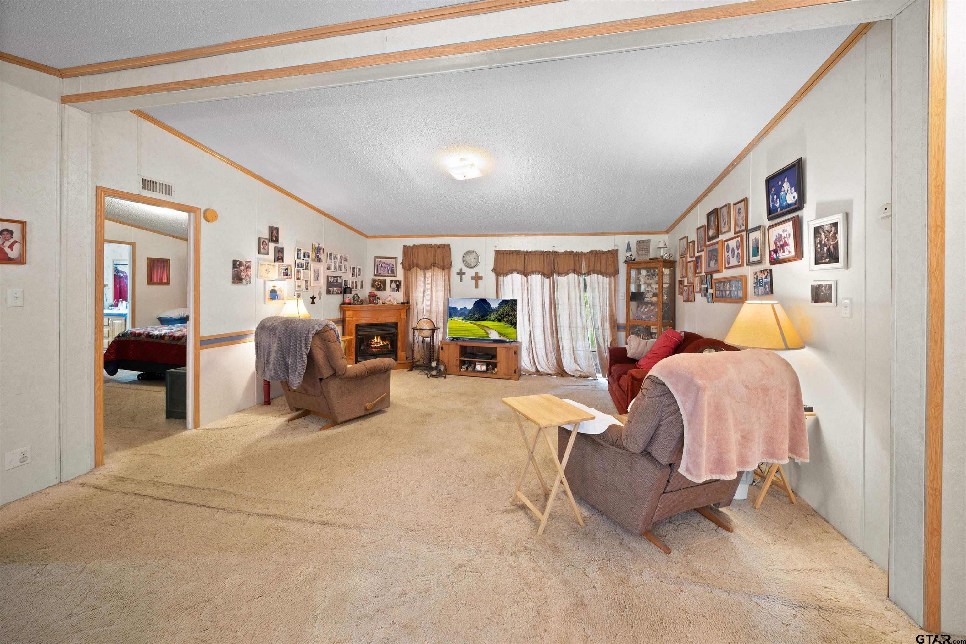 2425 Thompson Lane Tyler, TX 75704 - Photo 10 of 27 a bed room with a bed and a walk in closet