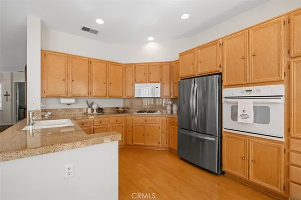 a kitchen with refrigerator cabinets and a sink