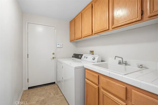 a utility room with sink dryer and washer