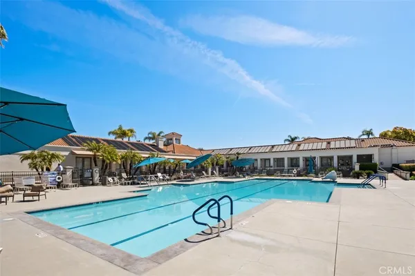 a swimming pool with an outdoor space and seating area