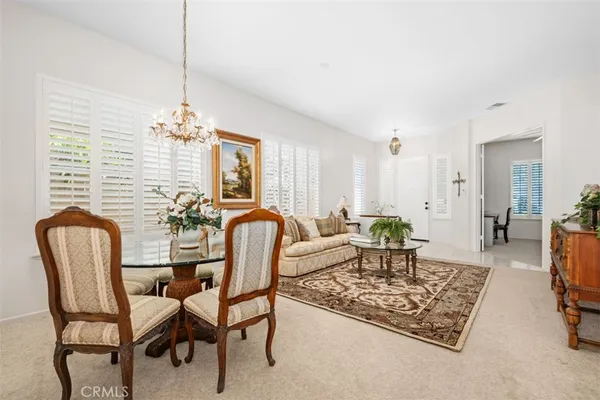 a dining room with furniture a rug and wooden floor