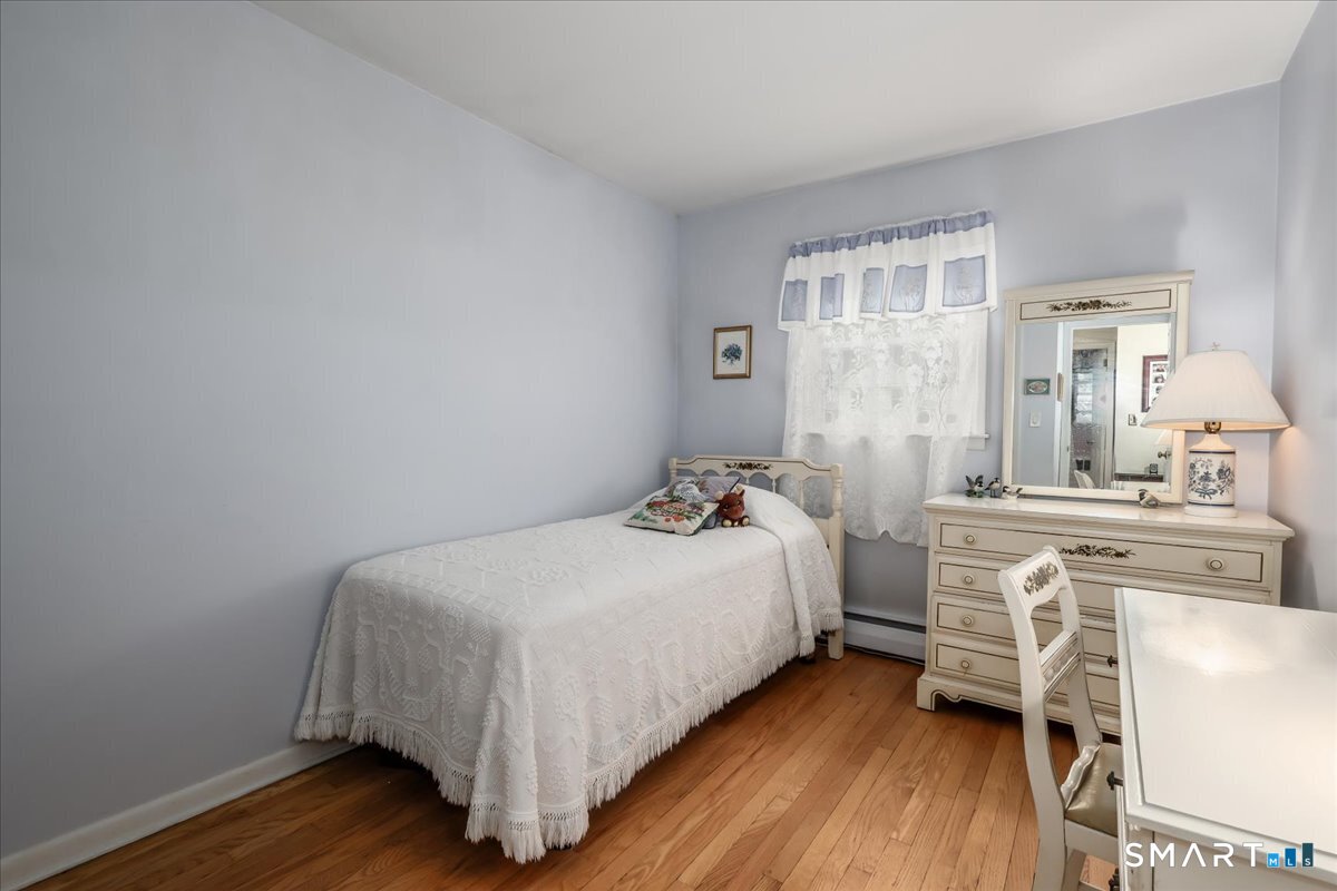 75 Centerbrook Road Fairfield, CT 06824 - Photo 24 of 39 2nd bedroom, hardwood floors, and built ins.
