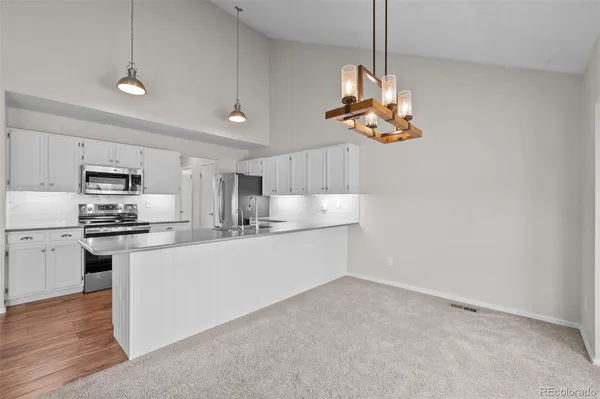a kitchen with a sink and chandelier