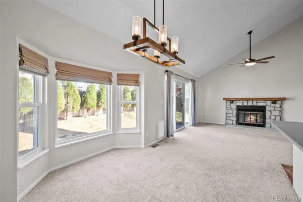 a view of empty room with fireplace and fan