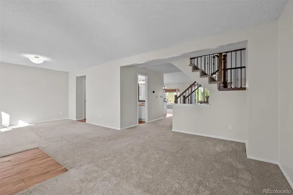 wooden floor in an empty room and a kitchen