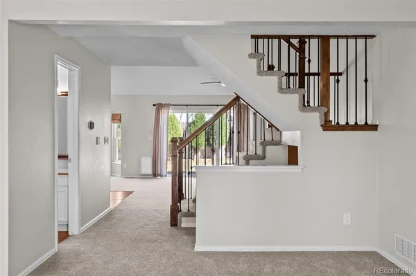 a kitchen with stainless steel appliances kitchen island granite countertop a sink stove and refrigerator