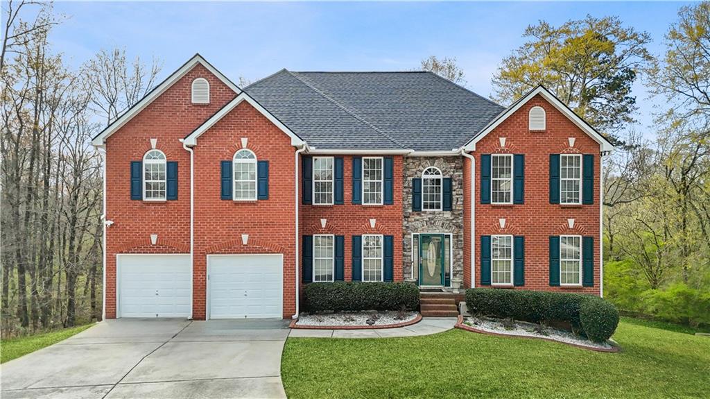 4320 Clarion Drive Conley, GA 30288 - Photo 1 of 49 a front view of a house with a yard and garage