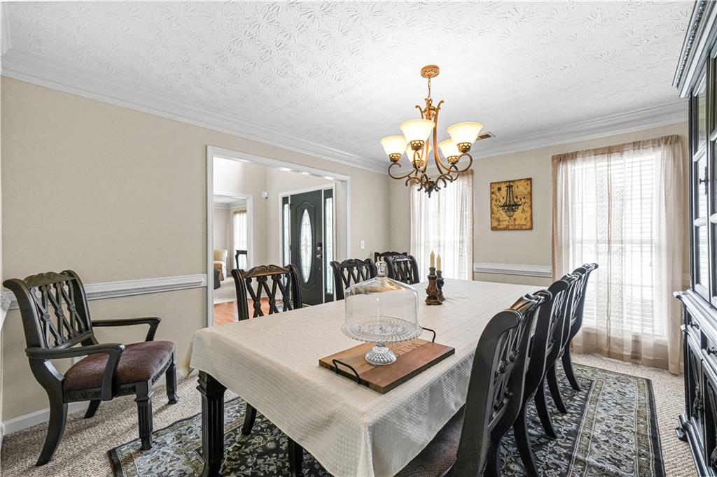 4320 Clarion Drive Conley, GA 30288 - Photo 12 of 49 a view of a dining room with furniture and a chandelier