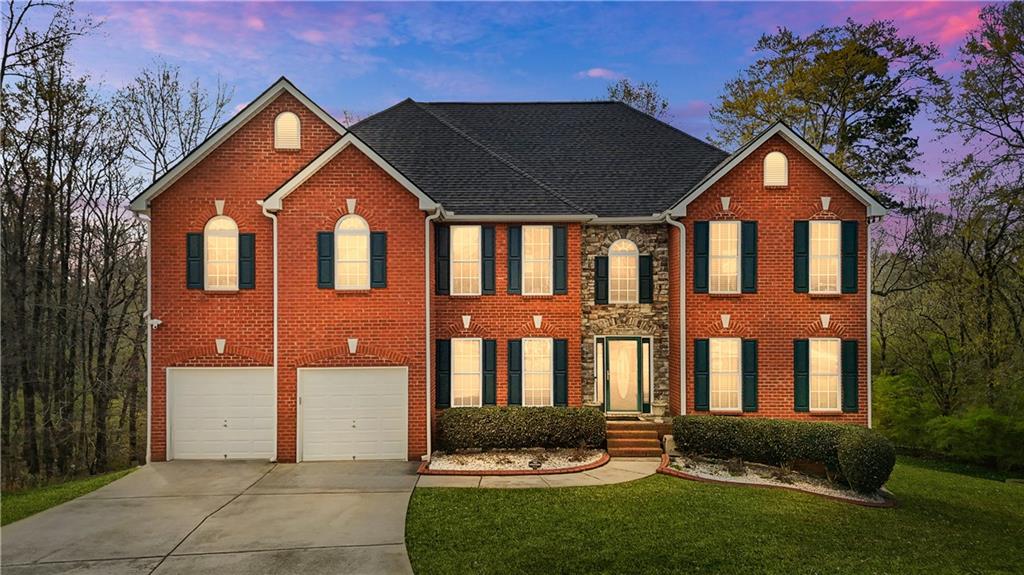 4320 Clarion Drive Conley, GA 30288 - Photo 2 of 49 a front view of a house with a yard and garage