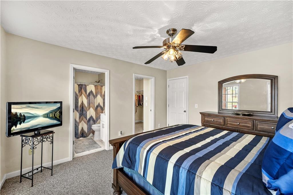 4320 Clarion Drive Conley, GA 30288 - Photo 25 of 49 a bedroom with a bed and a flat screen tv