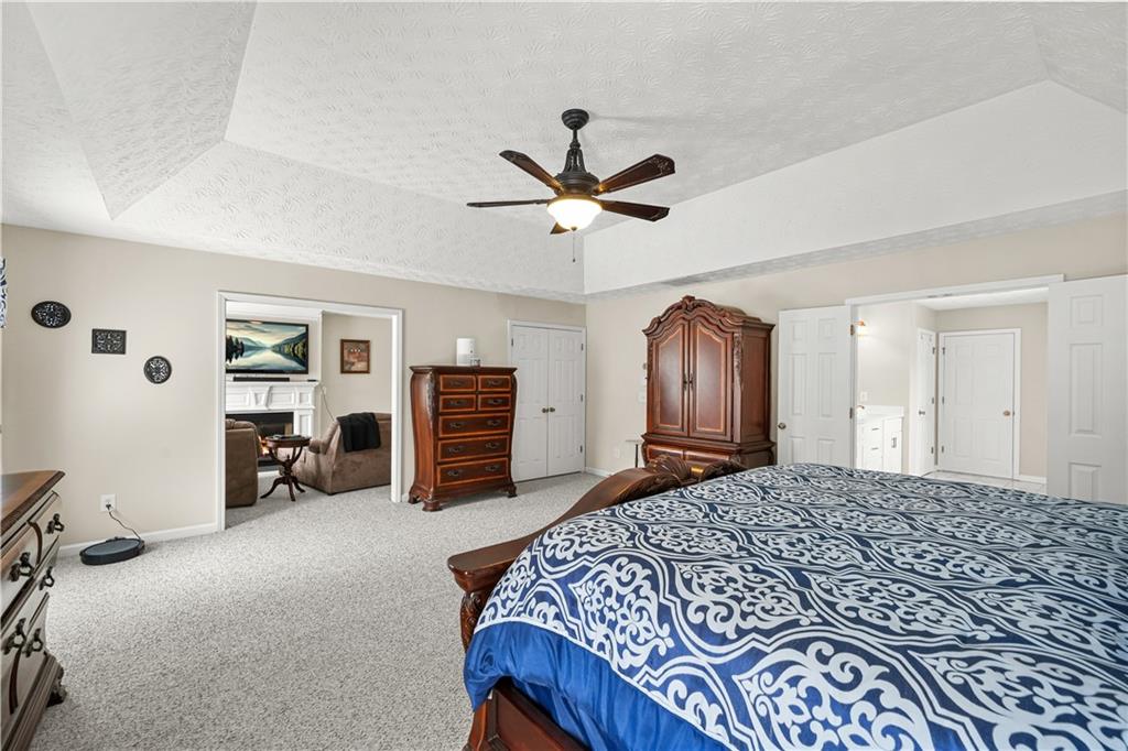 4320 Clarion Drive Conley, GA 30288 - Photo 31 of 49 a bedroom with a large bed and a chandelier