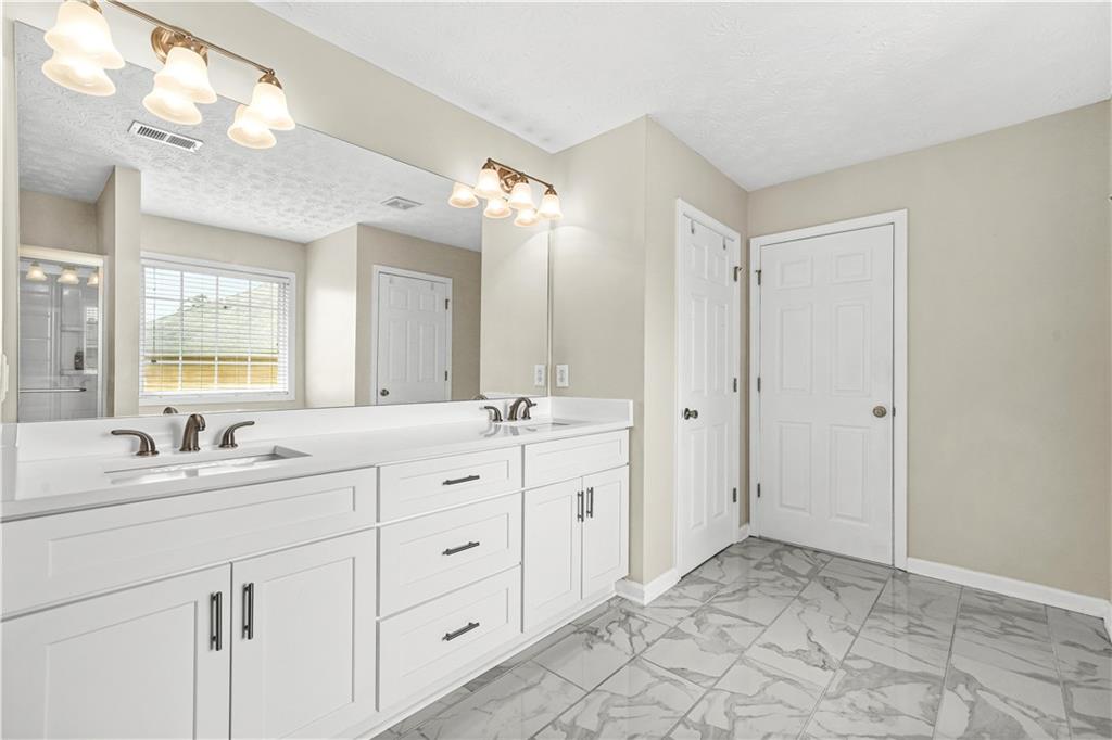 4320 Clarion Drive Conley, GA 30288 - Photo 32 of 49 a spacious bathroom with a double vanity sink mirror and double