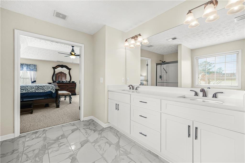 4320 Clarion Drive Conley, GA 30288 - Photo 33 of 49 a en suite bathroom with double sink and a mirror