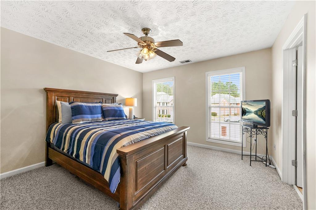 4320 Clarion Drive Conley, GA 30288 - Photo 35 of 49 a bedroom with a bed and a chandelier