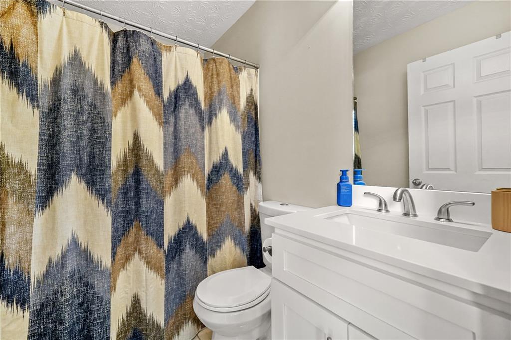 4320 Clarion Drive Conley, GA 30288 - Photo 36 of 49 a bathroom with a sink a toilet and a mirror