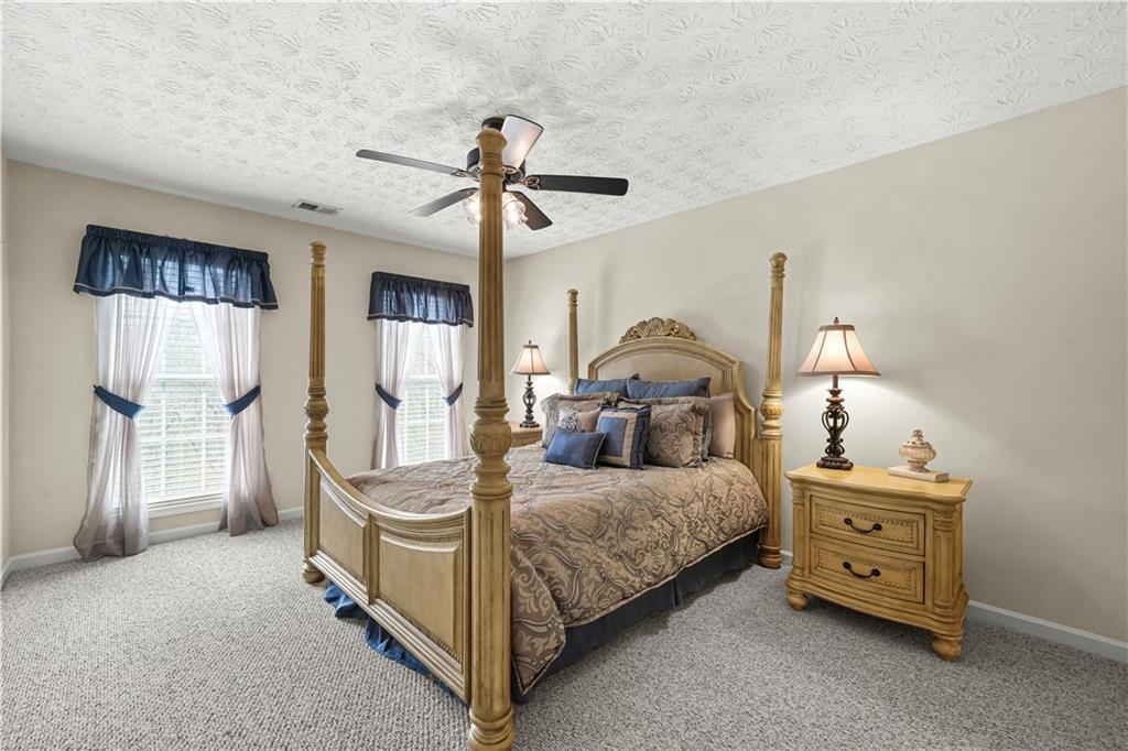 4320 Clarion Drive Conley, GA 30288 - Photo 37 of 49 a bedroom with a bed and a chandelier