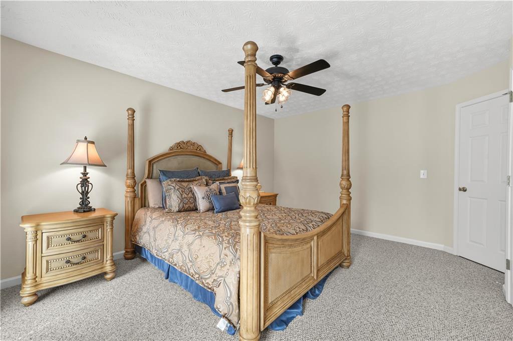 4320 Clarion Drive Conley, GA 30288 - Photo 38 of 49 a bedroom with a bed and a chandelier