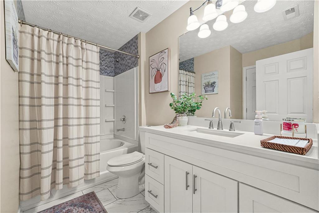 4320 Clarion Drive Conley, GA 30288 - Photo 39 of 49 a bathroom with a sink a toilet and shower curtain