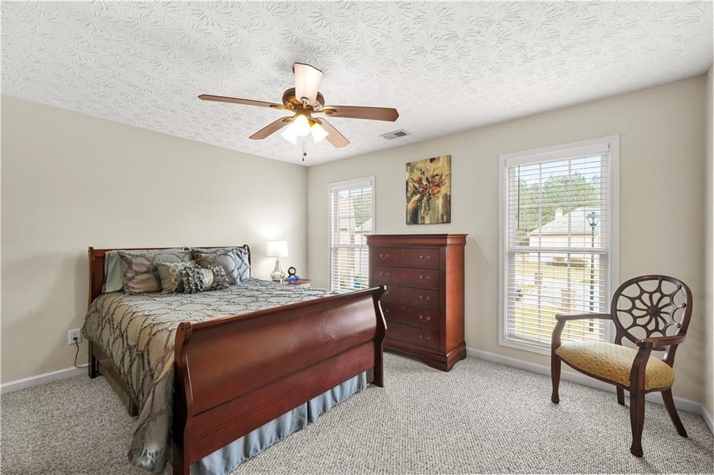 4320 Clarion Drive Conley, GA 30288 - Photo 40 of 49 a bedroom with a bed a chair and a large window